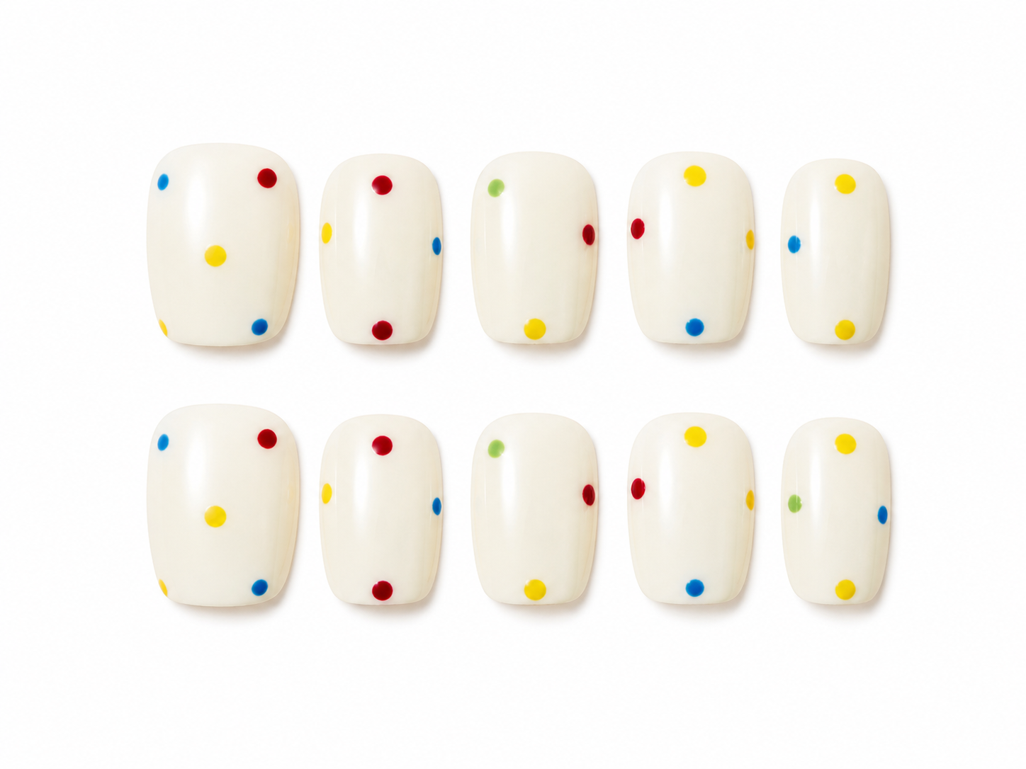 Set of short square press-ons, creamy white with a scatter of bright polka dots in red, yellow, blue, and green on a white background.
